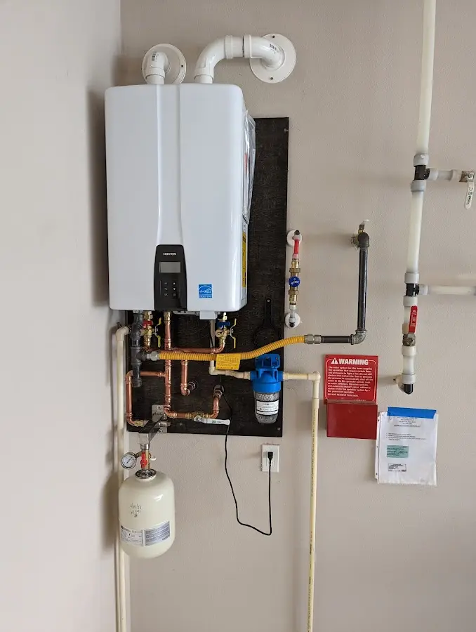 Professional plumber installing copper piping in a Cushing home